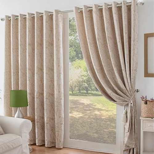 Textured beige eyelet curtains in living room