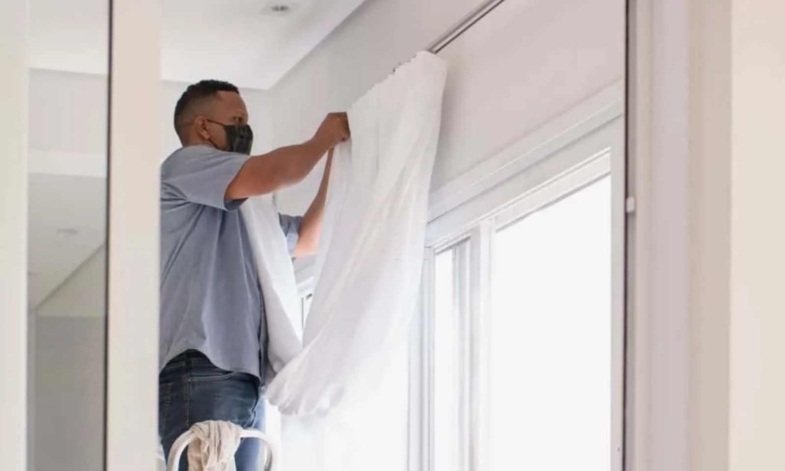 Technician installing custom linen curtains