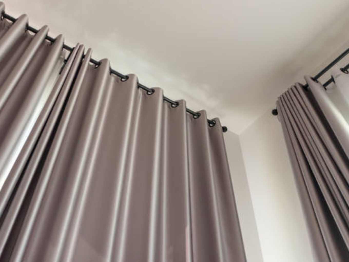 Professional installing eyelet curtains in Dubai