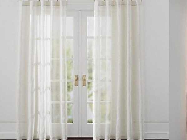 Sheer white linen curtains in sunlight